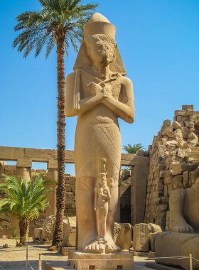 Pharaoh statue in anscient Temple of Karnak in Luxor - Ruined Thebes Egypt clipart
