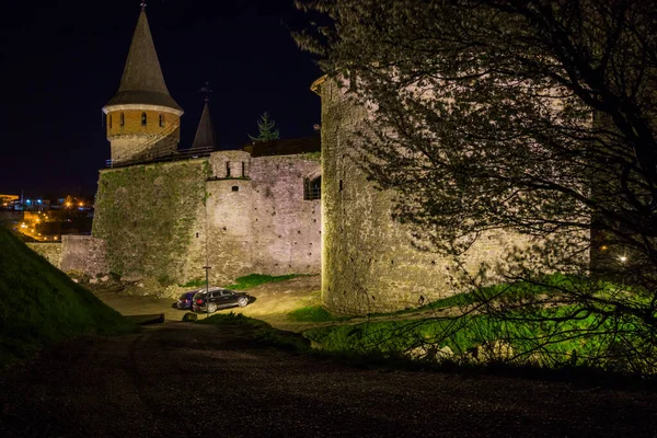 View on the Kamianets-Podilskyi castle in the night. Beautiful stone castle on the hill at night. Long exposure. Illumination of the castle. Ukraine