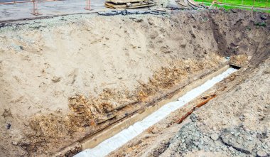 Değiştirildikten sonra kazılmış su boruları mı? Eski evin yanındaki koruyucu beyaz çantada. Boru hattı. Boru hattının değiştirilmesi.