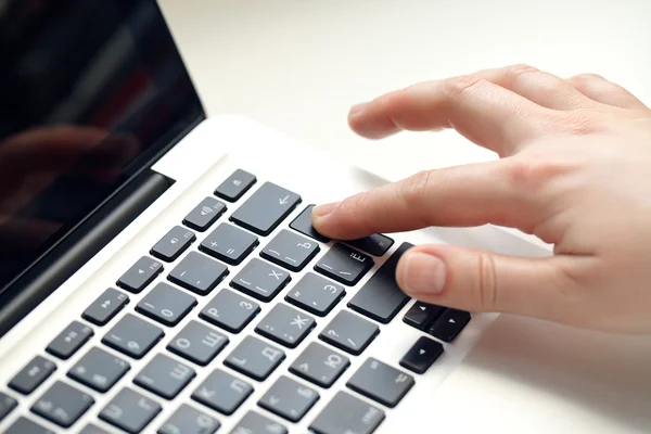 Image of human hands pressing keys of laptop Stock Photo