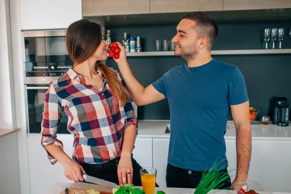 Genç çift mutfakta yiyecek hazırlama. Onun kız adam yayınları