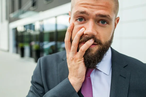 Young businessman having headache because of problems at work. — Stock Photo, Image