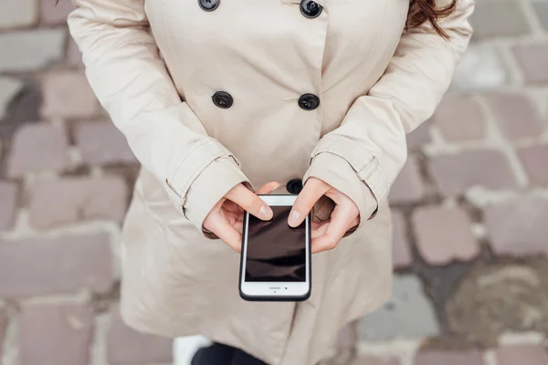 Girl using mobile phone. Urban background. Close up. — Stock Photo, Image