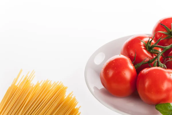 Fresh red tomatoes and pasta — Stock Photo, Image