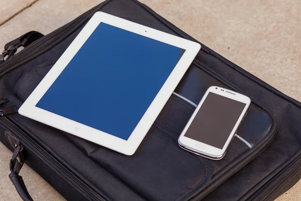 Tablet and mobile phone on a bag — Stock Photo, Image