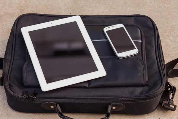 Tablet and mobile phone on a bag — Stock Photo, Image
