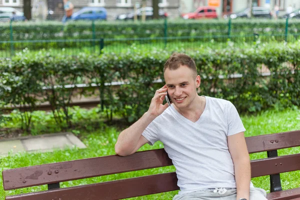 Man talking on phone in park — Stock Photo, Image