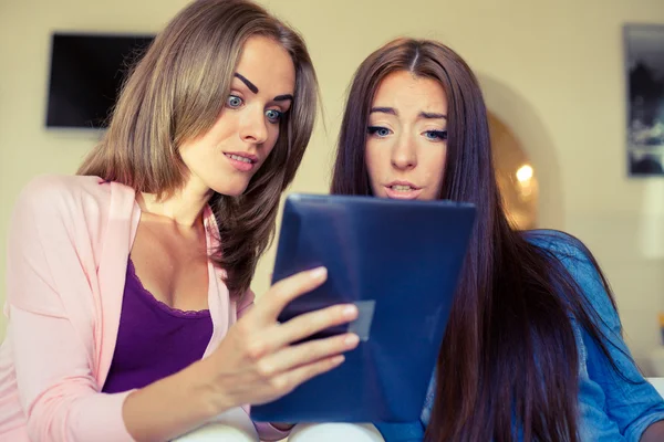 Two cheerful friends looking tablet pc. — Stock Photo, Image