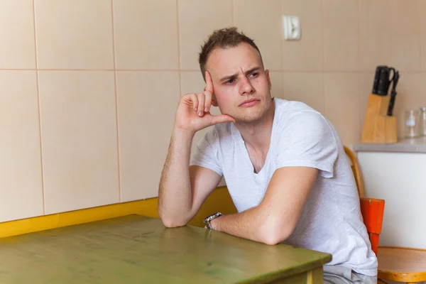 Man sitting in the kitchen — Stock Photo, Image