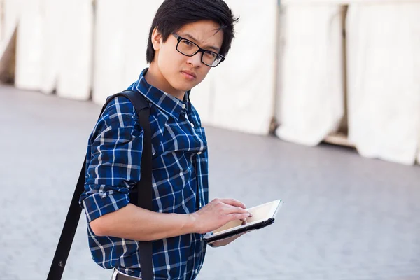 Male asian student with digital tablet — Stock Photo, Image