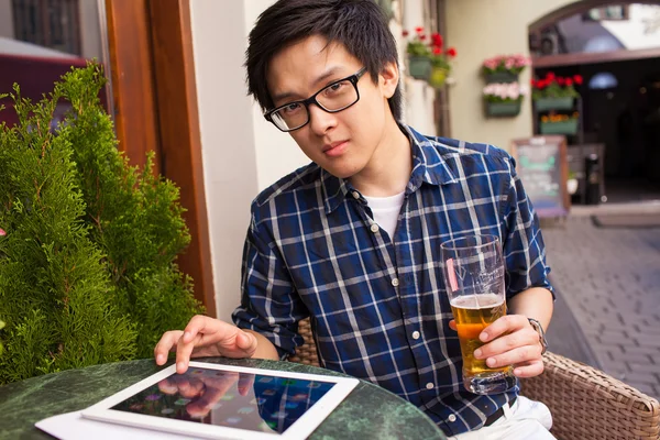 Adam bira içme ve tablet PC'yi kullanma — Stok fotoğraf