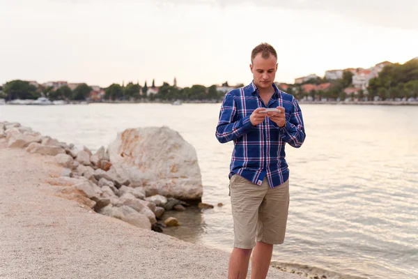 Mann am Strand und telefoniert. — Stockfoto