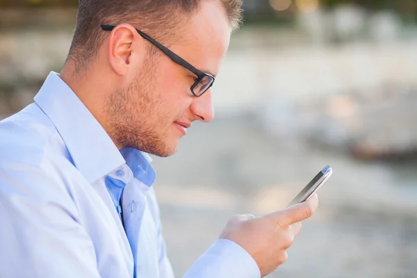 Young tourist with mobile phone — Stock Photo, Image