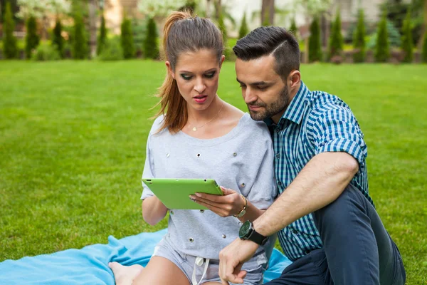 Coppia sulla coperta utilizzando tablet — Foto Stock