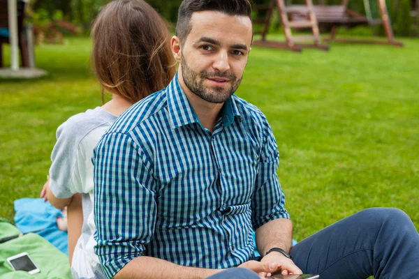 Couple sitting on the blanket — Stock Photo, Image