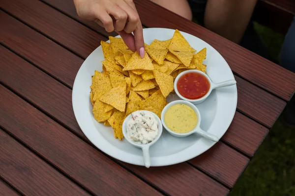 Woman hand and tortilla-chips — Stock Image Woman hand and tortilla-chips Stock Photo