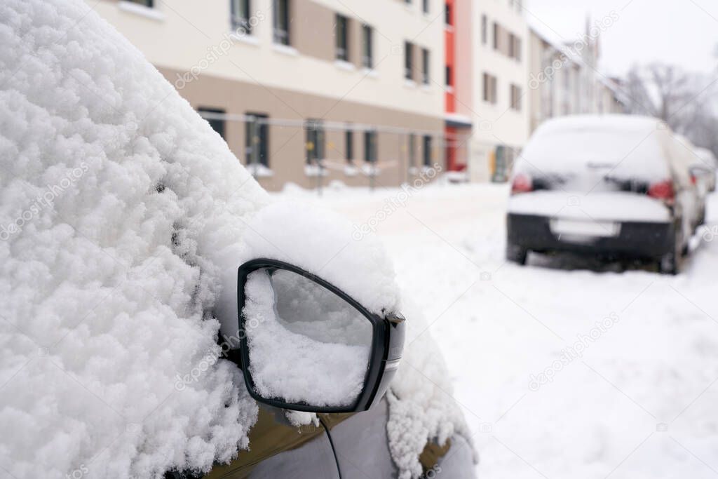 Snowed-in cars in a street in the city center of Magdeburg in Germany in Winter                               