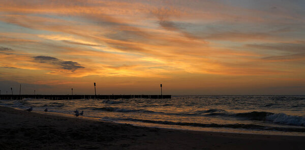     Evening atmosphere on the beach of the Polish Baltic coast near Kolobrzeg after sunset                             