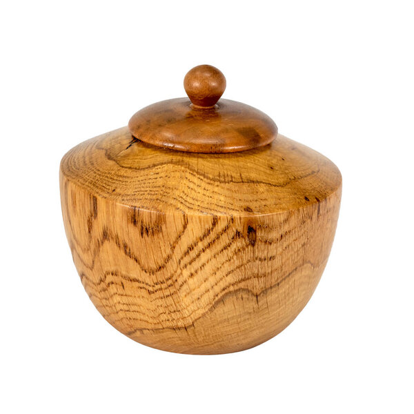 Side view of a turned oak wood jar with lid