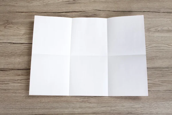 Close up of a crumpled unfolded piece of paper on wooden backgro — Stock Photo, Image