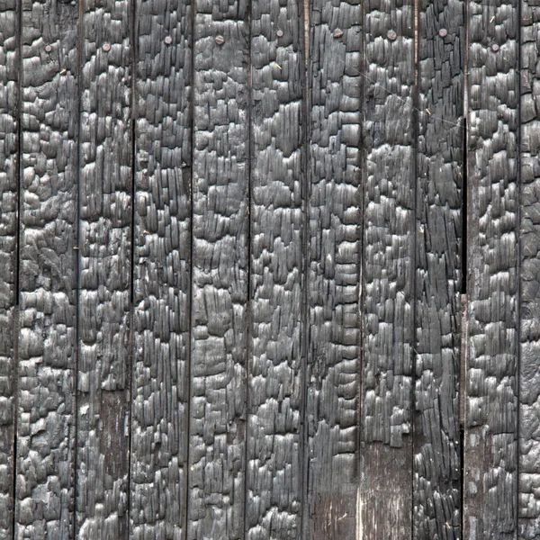 Lättnad textur av trä brann, närbild. — Stockfoto