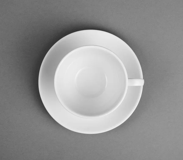 White mug and saucer on a gray background — Stock Photo, Image