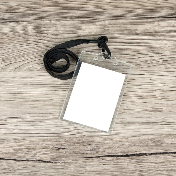 Name id card badge with cord on wooden background. — Stock Photo, Image