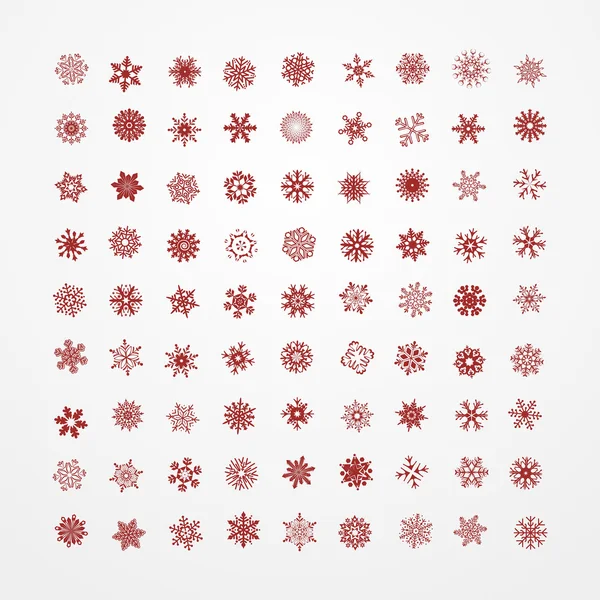 Coleção de flocos de neve vermelhos sobre um fundo branco . — Vetor de Stock