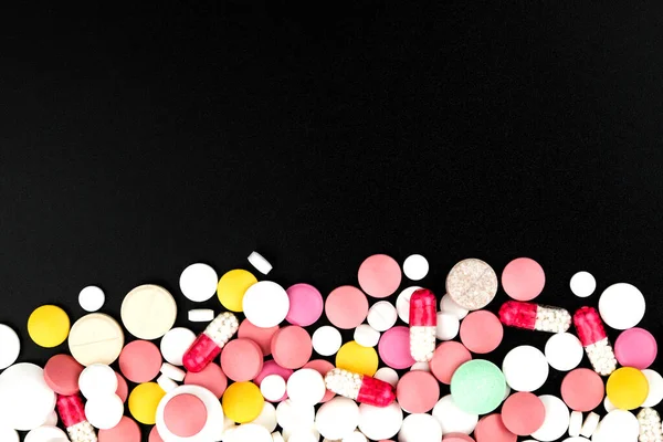 Background of assorted pharmaceutical capsules and medication in different colors