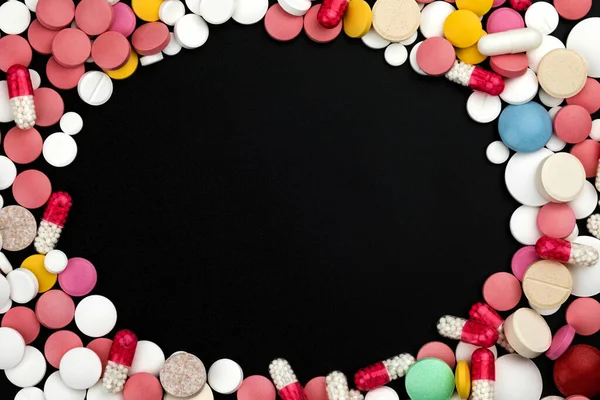 Background of assorted pharmaceutical capsules and medication in different colors