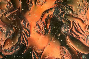 Su üzerindeki yağ baloncukları cam tankta soyut biçimdedir.