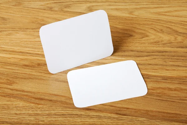 Blank business cards with rounded corners on a wooden background — Stock Photo, Image