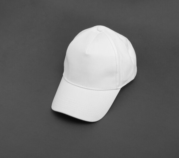 White baseball cap on gray background.