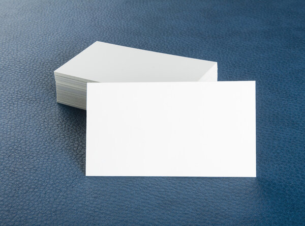 blank business cards on blue leather background