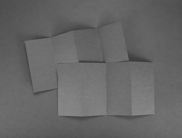 Folleto de papel en blanco sobre fondo gris . —  Fotos de Stock