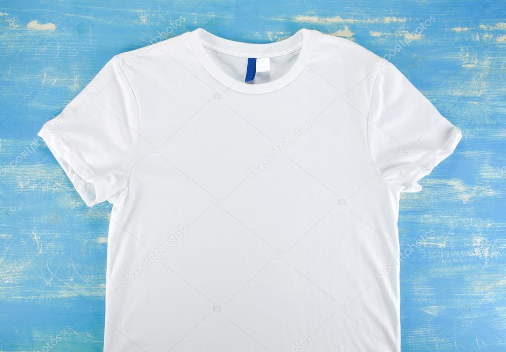 White t-shirt template on a blue wooden background.