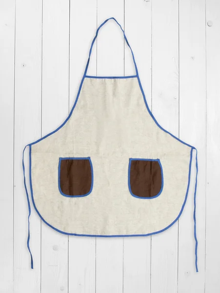 Blank apron with pockets on white wooden background. — Stock Photo, Image