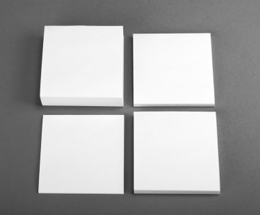 Collection of white note papers on gray background. clipart