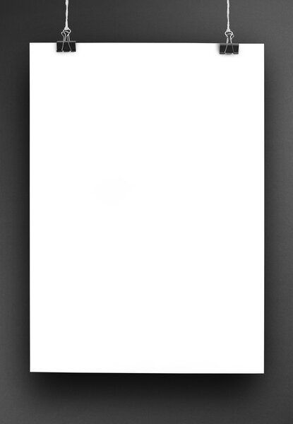 Poster hanging on a thread with two black clips.