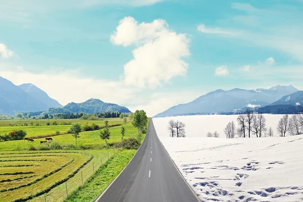 Country road through winter and spring landscape — Stock Photo, Image