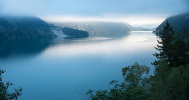 Sabahları Achensee Gölü 'nün üzerinde sis, yorgun bir manzara.