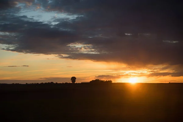 Paisagem Rural Com Sol Afundando Nuvens Cinzentas Brilho Alaranjado — Fotografia de Stock