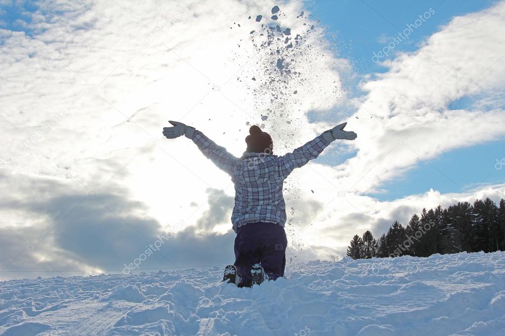 teenage girl throwing snow