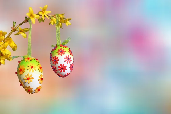 Pastel colored background, branch with group of easter eggs — Stock Photo, Image