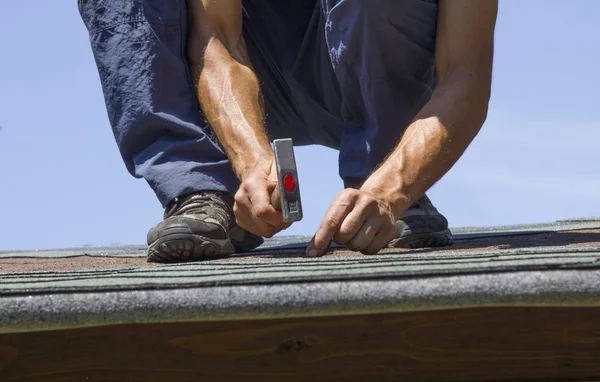 Gardener repairing roof of summer garden house — Stock Image Gardener repairing roof of summer garden house Stock Image