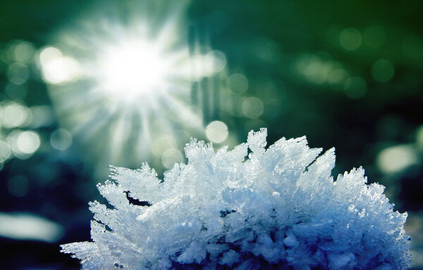 stone with hoar frost and ice crystals, bright sunshine
