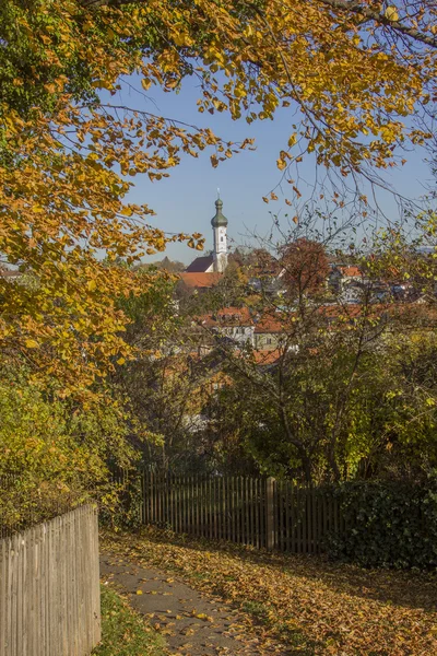 Village church bad tolz, view through autumnal branches — Stock Photo, Image