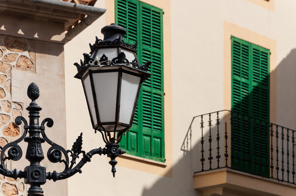 Electric lamp on house with balcone in the street
