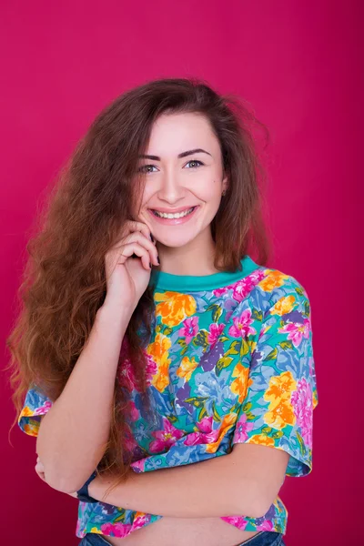 Young beautiful woman having fun on red background — Stock Fotó