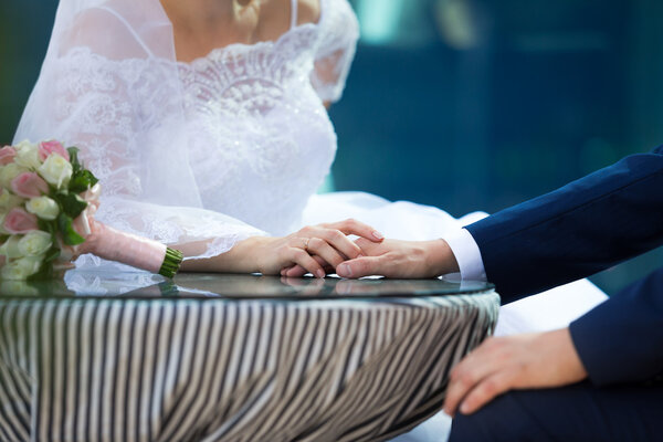 Bride holding groom hand